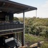 Lanai & garage with Resource Furniture Flex sofas, Modern Fan IC/Air3 fan, Rich Brilliant Willing Crisp (copper) lighting and electrified 1973 VW Thing by Hawaii Off-Grid, Graham Hill with Kazuma surfboard.